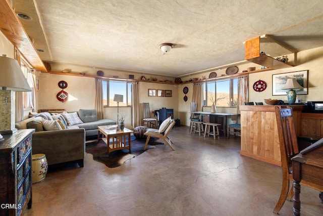 living area featuring concrete flooring and a textured ceiling