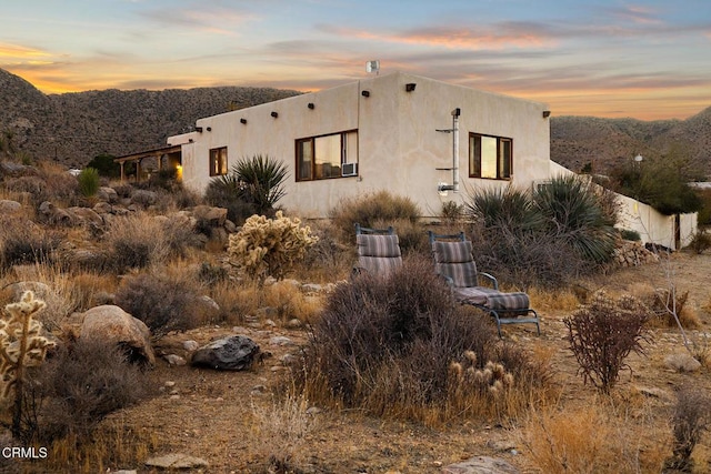 pueblo-style home with a mountain view and stucco siding