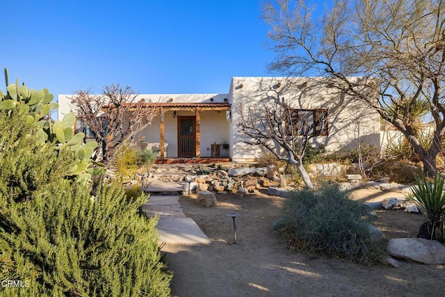 view of front of home with a tile roof and stucco siding