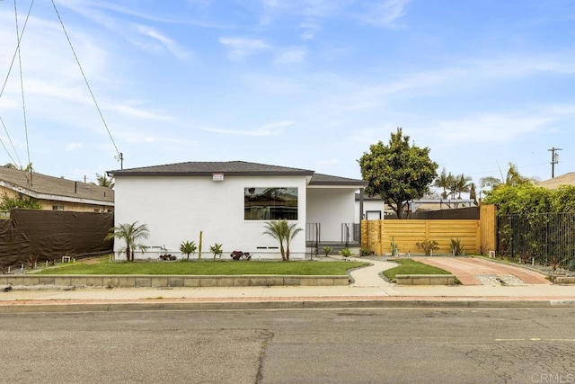 view of front of home with fence and stucco siding