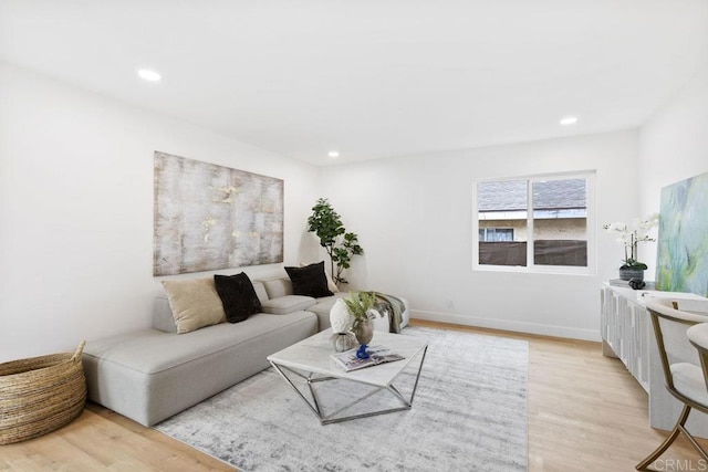 living area with recessed lighting and light wood-style flooring