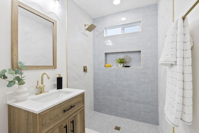 full bathroom featuring vanity and tiled shower
