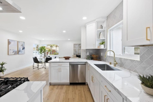 kitchen featuring stainless steel dishwasher, light wood-style flooring, a sink, backsplash, and open shelves