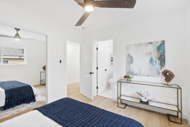 bedroom with a ceiling fan, wood finished floors, and ensuite bathroom