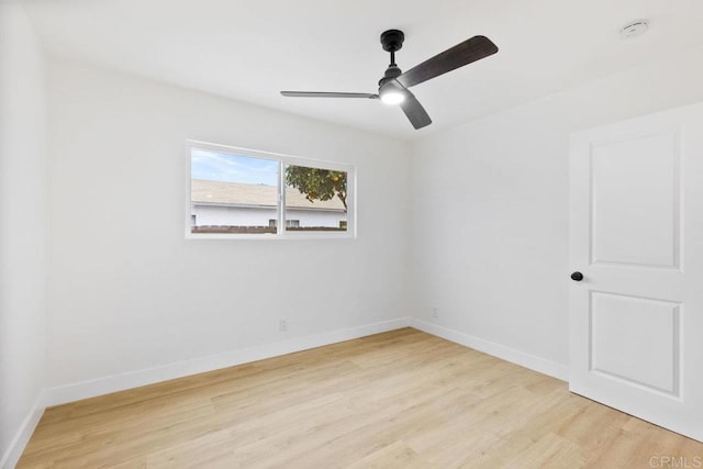 unfurnished room with ceiling fan, baseboards, and light wood-style floors