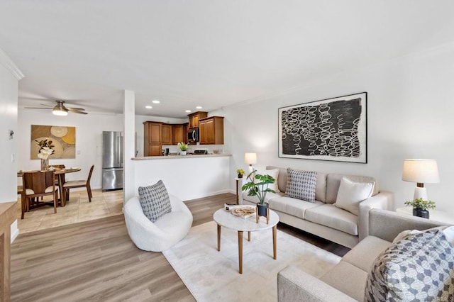 living area with light wood-style floors, recessed lighting, and a ceiling fan