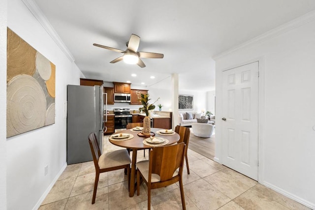 dining room with crown molding, light tile patterned floors, recessed lighting, ceiling fan, and baseboards