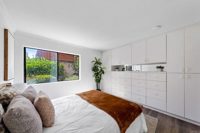 bedroom featuring dark wood-style floors and ornamental molding