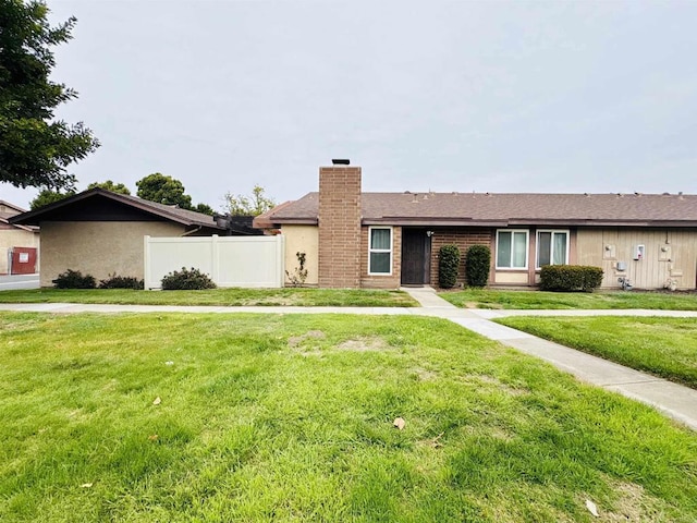 single story home with a chimney, fence, a front lawn, and stucco siding