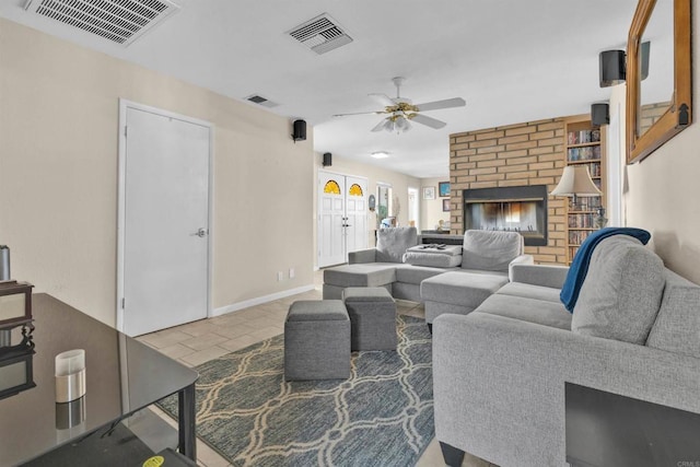 living room with ceiling fan, a fireplace, and visible vents