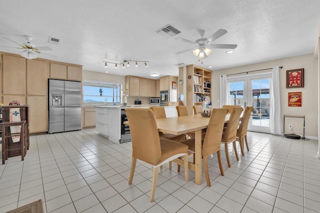 dining room with french doors, light tile patterned flooring, and visible vents