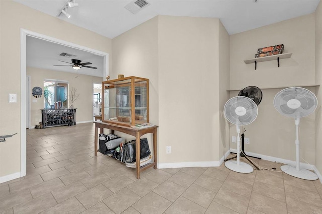 interior space with light tile patterned floors, rail lighting, visible vents, ceiling fan, and baseboards