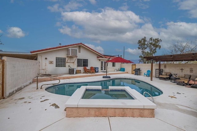 view of pool featuring central AC unit, a patio area, a fenced backyard, and a pool with connected hot tub