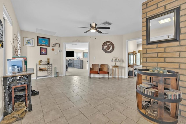 living room featuring visible vents, ceiling fan, baseboards, and light tile patterned floors