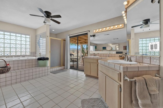 bathroom with a healthy amount of sunlight, a sink, and tile patterned floors