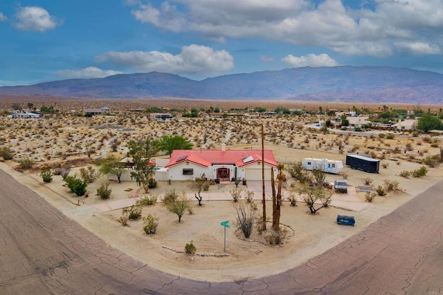 birds eye view of property with a mountain view and view of desert