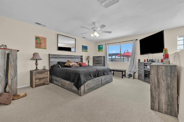 bedroom with visible vents, light carpet, and multiple windows