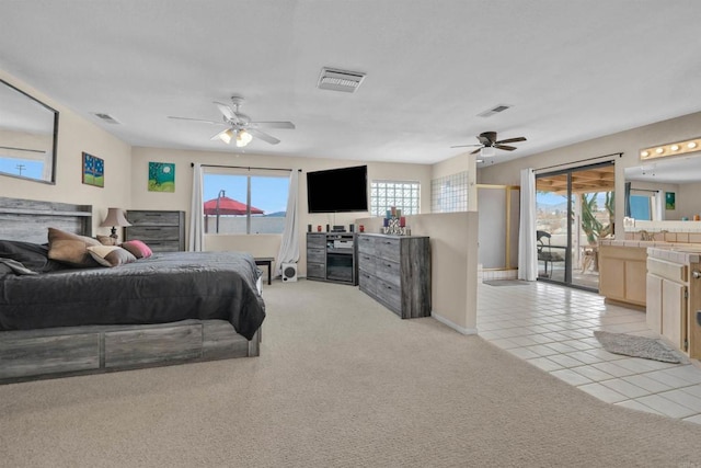 bedroom featuring light carpet, multiple windows, and visible vents