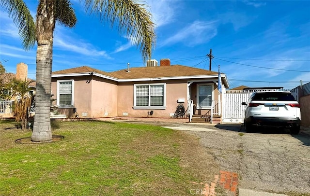 exterior space with crawl space, a yard, fence, and stucco siding