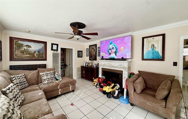 living area with a fireplace, ornamental molding, a ceiling fan, and light tile patterned flooring