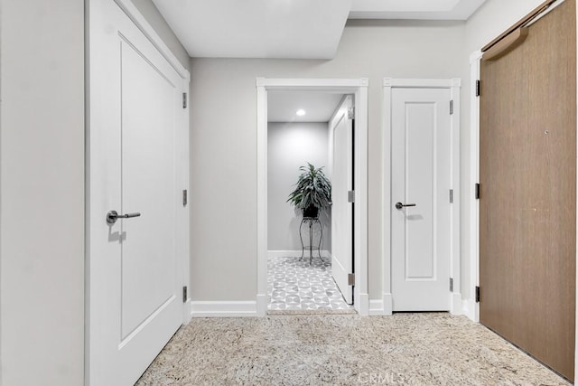 hallway featuring baseboards