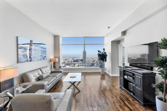 living area with dark wood-type flooring and baseboards