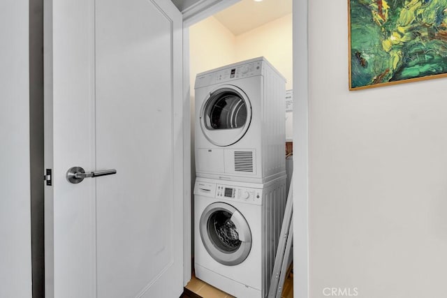 laundry area featuring stacked washing maching and dryer and laundry area