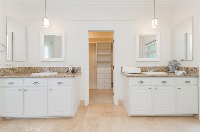 bathroom with two vanities, a sink, and crown molding