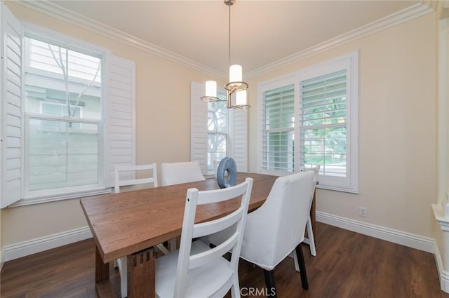 dining room with ornamental molding, dark wood-type flooring, an inviting chandelier, and baseboards