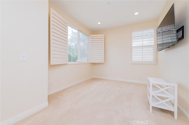 carpeted empty room featuring recessed lighting and baseboards