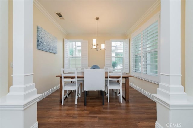 dining space with dark wood-type flooring, plenty of natural light, visible vents, and crown molding