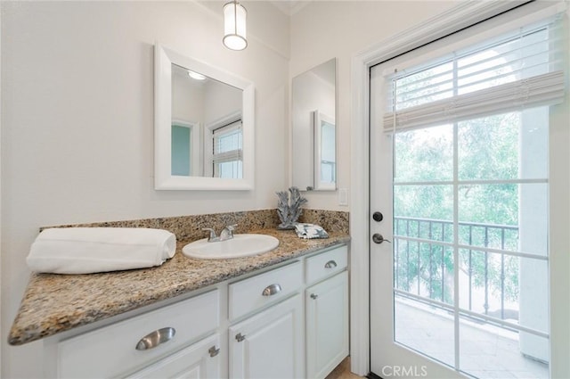 bathroom featuring a wealth of natural light and vanity