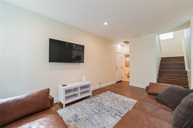 living area with recessed lighting, visible vents, stairway, wood finished floors, and baseboards