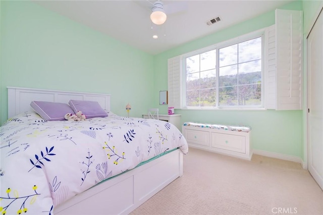 bedroom with visible vents, ceiling fan, light carpet, and baseboards