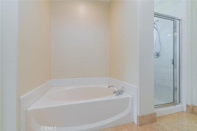 full bathroom with a garden tub and a shower stall