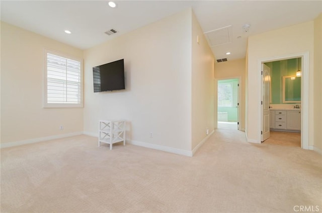 empty room featuring light carpet, a wealth of natural light, and visible vents