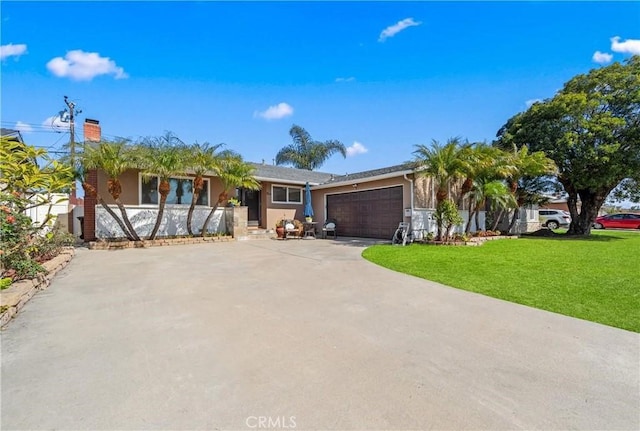 single story home featuring a front yard, concrete driveway, an attached garage, and stucco siding