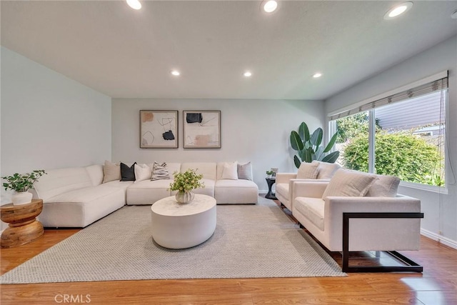 living area featuring recessed lighting, baseboards, and wood finished floors