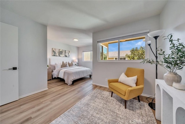 bedroom featuring baseboards and wood finished floors