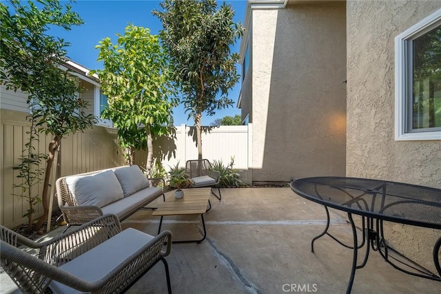 view of patio / terrace with outdoor lounge area and fence