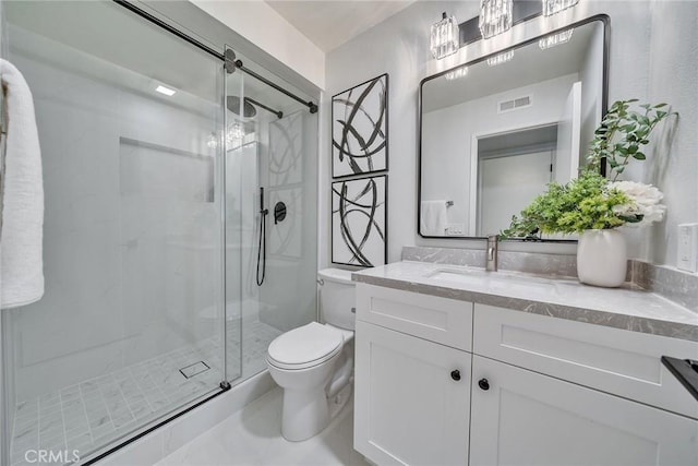 full bathroom featuring visible vents, a stall shower, vanity, and toilet