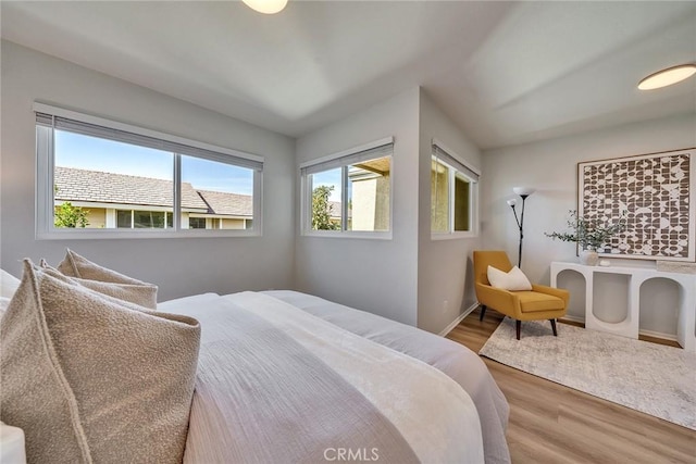 bedroom featuring wood finished floors and baseboards