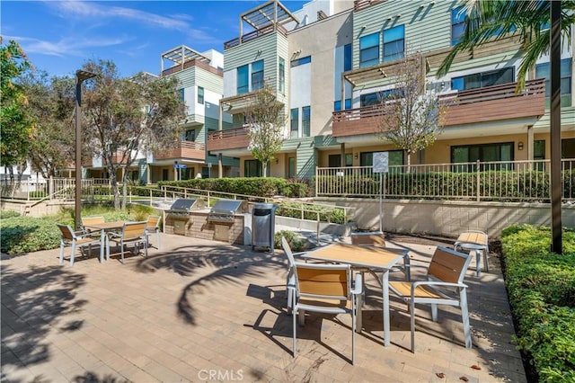 view of patio featuring outdoor dining area and exterior kitchen