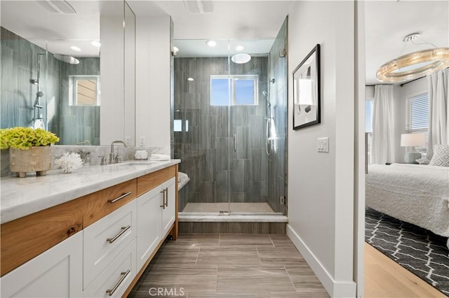 bathroom with vanity, ensuite bath, plenty of natural light, and a stall shower