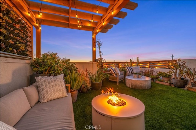 view of patio / terrace with fence, an outdoor living space with a fire pit, and a pergola