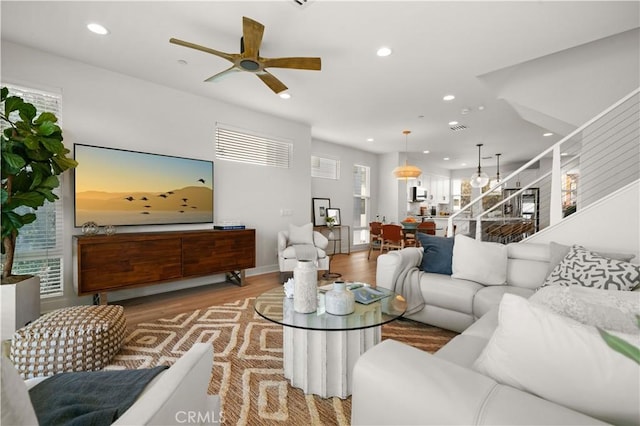 living room with visible vents, baseboards, ceiling fan, recessed lighting, and light wood-style floors