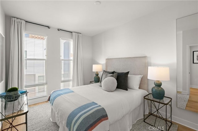 bedroom with wood finished floors and baseboards