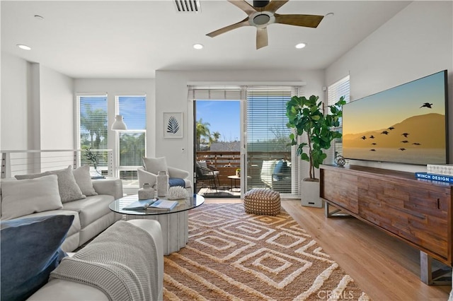 living area featuring a ceiling fan, recessed lighting, visible vents, and light wood finished floors