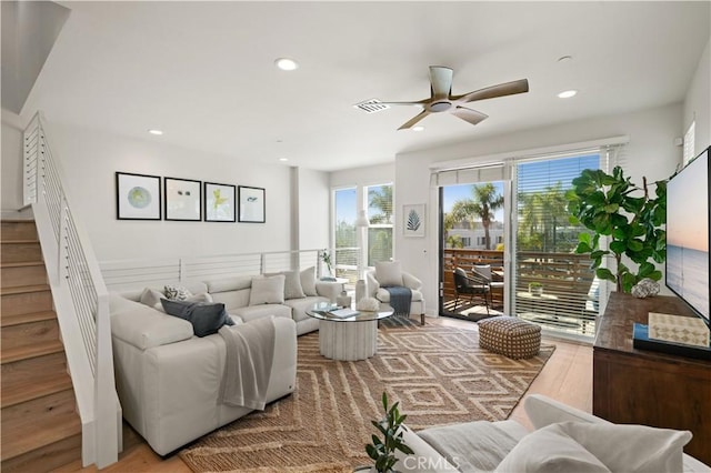 living room featuring recessed lighting, visible vents, ceiling fan, and stairs