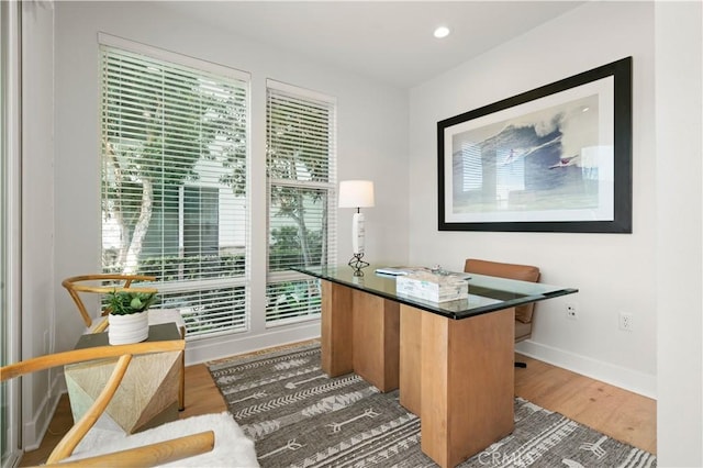 home office with recessed lighting, light wood-style floors, and baseboards